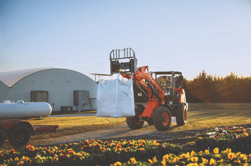 Man loading material onto back of trailer