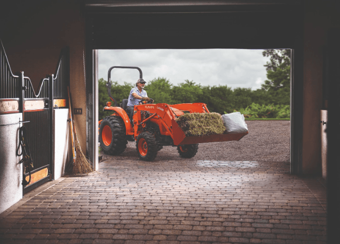 Man using tractor to carry materials in the bucket