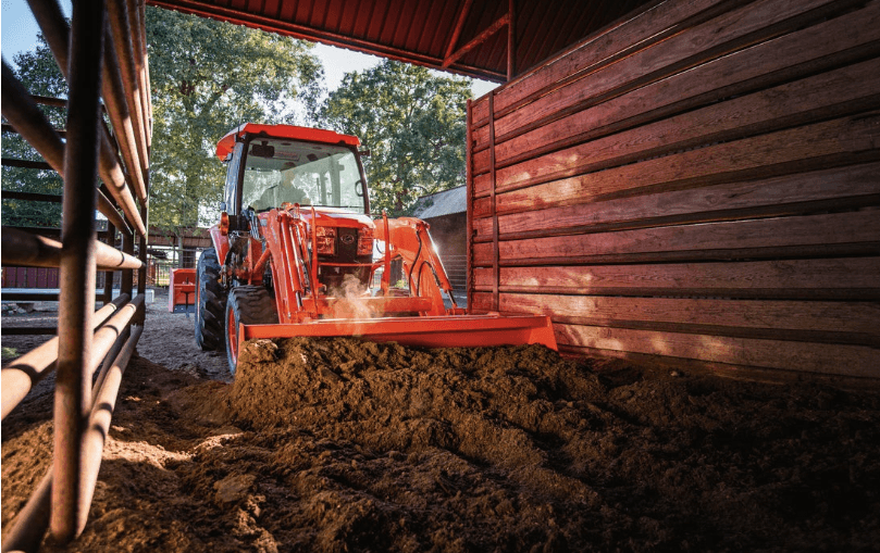 Tractor clearing out stable