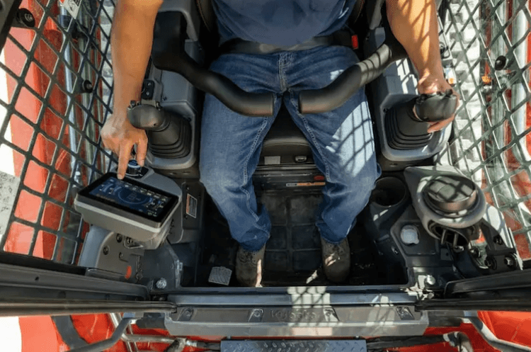 Close-up shot of the operator inside of track loader