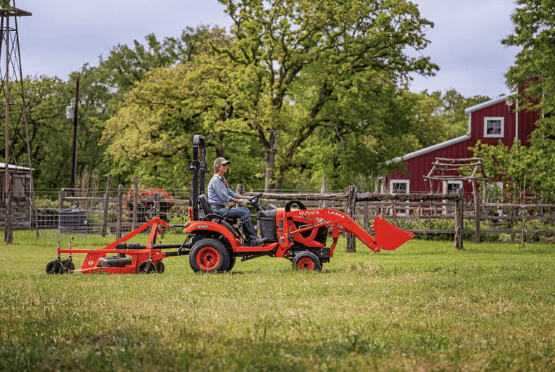 Woman driving sub-compact through a field