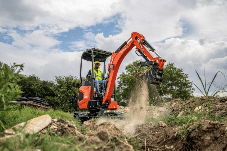Man using an excavator on site