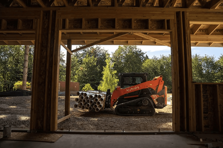 Loader moving pipes through job site