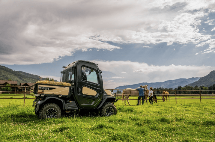 RTV taking hay in cargo bed out to horses